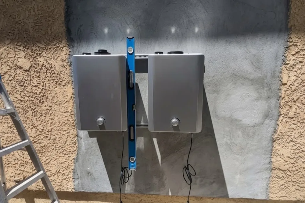 Wall-mounted tankless water heater unit installed in a garage utility area
